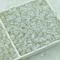 Macro shot of clear cracked glass round beads for DIY jewelry making in a white tray - 6mm / White