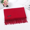 Red cashmere feel scarf with fringe trim and brand tag on a professional tabletop setup - Burgundy