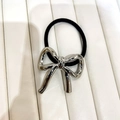 Detail of silver metallic bow ornament on a premium black elastic hair tie for women - Style C / Silver