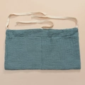 Detailed texture of teal muslin cotton crib organizer with large double pockets - Dark Blue