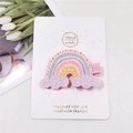 Detail of glitter rainbow hair clip with purple clouds on white display card - Iridescent Lucky Cloud