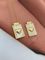 Macro shot of rectangular gold necklace pendant with white shell inlay and heart relief - Necklace B-Heart