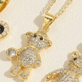 Macro shot of 14K gold plated bear pendant encrusted with sparkling white zircon stones - Standing Zirconia Bear Necklace (XL2457)