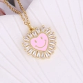 Gold necklace with pink heart smiley face pendant and crystal sunburst frame - Pink