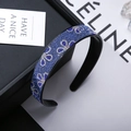 Sparkling dark blue rhinestone headband with wide band design and interlocking patterns - Three-Leaf Light Blue