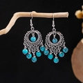 Close-up of bohemian silver earrings with turquoise beads on a wooden display - E5775-16/Silver Alloy Turquoise Texture Bead