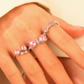 Three-piece ring set with silver band featuring pink heart-shaped zircons on hand - Pink Heart Bow Style (11261) / Pink