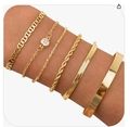 Five-piece layered gold Cuban chain and butterfly bracelet set worn on wrist - Golden Bangle and Multi-Chain Mixed Layered Style