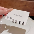 Macro detail of 6-piece silver earring set with cat eye stones and small pearls - Black Enamel Zircon Set
