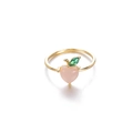 Detailed macro view of peach ring with pink stone and green leaf on golden band - Peach Shape