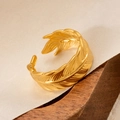 Detailed close-up of adjustable 18k gold plated feather ring on silk fabric and wood base - Feather Style (18) / Gold