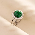 Detail of an open silver ring with a round green malachite stone on soft fabric - Silver Malachite Style / Silver Green (J566-S-G)