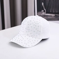Detail view of a white baseball cap featuring floral lace texture and rainbow rhinestones - One Size / White