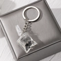 Close-up of tropical fish water bag pendant with silver keychain and resin detail - Black Small Fish