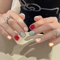 Detail of handmade press-on nails featuring red, blue, and yellow polka dot cat-eye designs - By1597 Colorful Red Dot / Glue Type