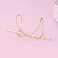 Minimalist gold metal hair pin with cross-wrapped geometric base on pink background - Large / Gold