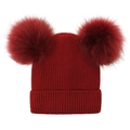 Detail of dark red knit beanie with dual fluffy faux fur pom poms and ribbed texture - Burgundy