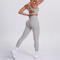 Close-up of light gray two-piece yoga set with open back sports bra and high waist leggings - Frost Grey