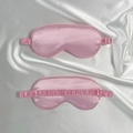 Pink satin sleep eye mask with elastic band shown on silk background - Pink