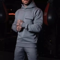 Men's grey hooded tracksuit with cargo pockets in a boxing gym training setting - Dark Gray