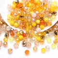 Macro shot of faceted yellow and champagne crystal glass beads spilling from a white bowl - Yellow Series