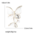 White butterfly brooch with rhinestones and gold base including dimensions 4.8cm by 3.5cm - White