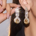 Elegant gold-tone oval drop earrings with yellow pear-shaped gemstone and sparkling crystals - Gold Pear-shaped Yellow Gem Style (DTE1316605GL-LT)
