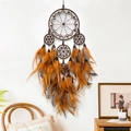 Brown handmade bohemian dreamcatcher with colorful feathers on a white wall decor - Brown