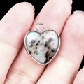 Silver-edged heart pendant featuring white spotted stone with black and blue veins - Kiwi Stone Silver Edging