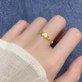 Interlocked heart link ring in 18k gold finish worn on model hand over denim background - Interlocked Heart Gold