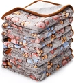 Close-up of stacked thick grey flannel pet blankets with colorful paw prints and soft texture - Coffee Paw Print