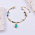 Double-layered beaded bracelet with gold chain and blue oval gemstone pendant - Oval