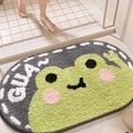 Cartoon frog plush bathroom mat in green and grey with GUA text and non-slip base - GUA Frog