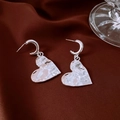 Detailed view of silver heart earrings with irregular lava texture on dark satin - Silver Hammered Heart Dangle Style (26#)