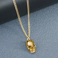 Close-up of golden 3D skull pendant with polished finish on a fine curb chain necklace - 55+5cm / Gold