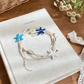 Detail of woven rope necklace with starfish, natural shells and gold beads on a book - Style 23#
