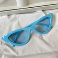 Light blue cat eye sunglasses with trendy polygon frame on soft white fabric background - Triangle Blue Frame Blue Lens Cat Eye