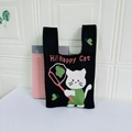 Knit tote bag featuring a cute white cartoon happy cat pattern on black fabric - Black Butterfly Cat