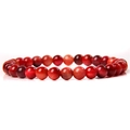 Close-up of 6mm red agate beads with cat eye effect on elastic gemstone bracelet - Light Red Tiger Eye
