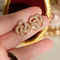 Detail of interlocking gold earrings with baroque pearls and baguette cut crystals - Spiral Pearl Double Hoop Earrings
