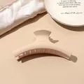 Matte beige large hair claw clip for thick hair shown on a minimalist prop background - Beige Matte-Hanger