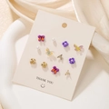 Lot de 6 boucles d'oreilles colorées avec nœuds violets et détails de croix dorée - Ensemble Perle Papillon de Rêve Violet (E0470-1)
