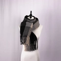 Detailed view of British style black gray beige plaid scarf with fringe on a mannequin - Black and White