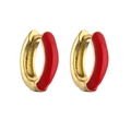 Close-up of gold huggie hoop earrings with vibrant red enamel finish on white background - Red