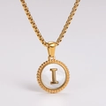Close-up of golden shell pendant with letter I and beaded texture on stainless steel chain - Letter I