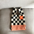 Knitted tote bag with black and white checkerboard pattern and orange flower detail - Black Checkerboard