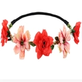 Detailed close-up of floral headband featuring red and pink faux flowers with green leaves - Red