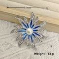 Silver flower brooch with blue enamel and pearls on a beige knitted background - Silver Sunflower