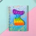Rainbow mermaid tail pop-it sensory toy on a glittery spiral notebook for kids - Fish Tail