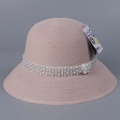 Detail of pink woven sun hat featuring luxury pearl band and UPF 50 plus protective tag - M(56-58cm) / Pink